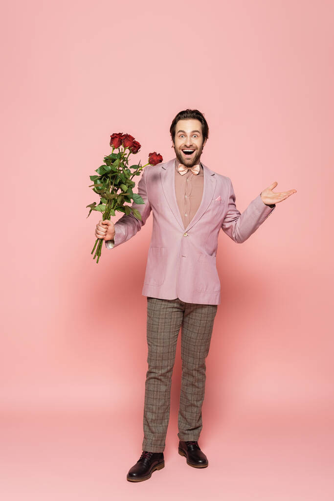 Innoissaan isäntä tapahtuman takki ja rusetti tilalla kimppu ruusuja vaaleanpunainen tausta  - Valokuva, kuva