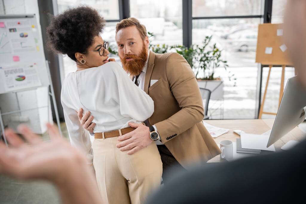 shocked african american woman getting caught by husband while cheating with bearded colleague in office - Fotoğraf, Görsel