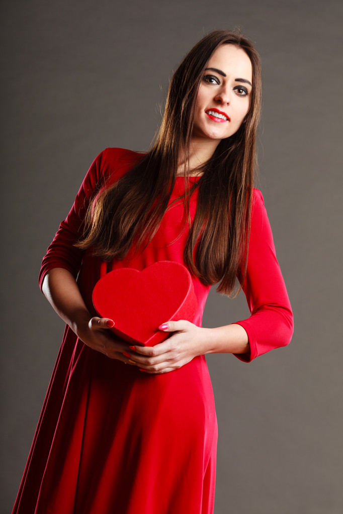 女性は赤いドレスを保持するハート型ボックス - 写真・画像