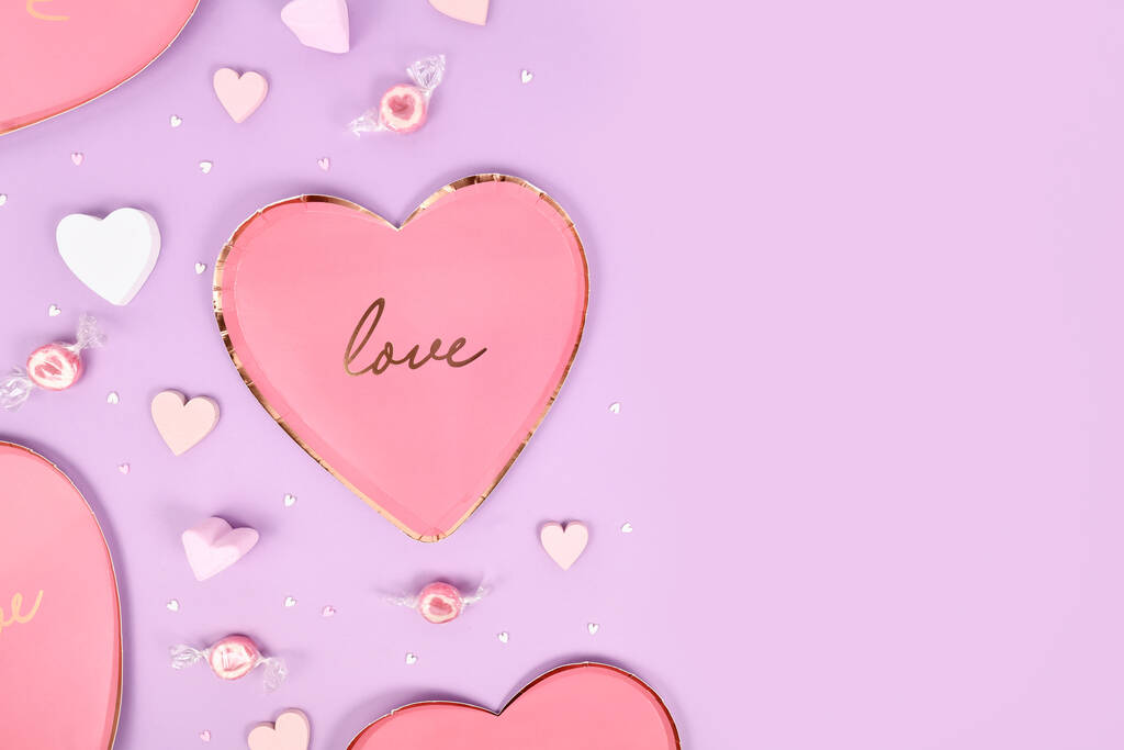 Пастельно окрашенная квартира ко Дню святого Валентина лежала с пластинками в форме сердца, сердечными орнаментами и свечой на фиолетовом фоне с копировальным пространством - Фото, изображение