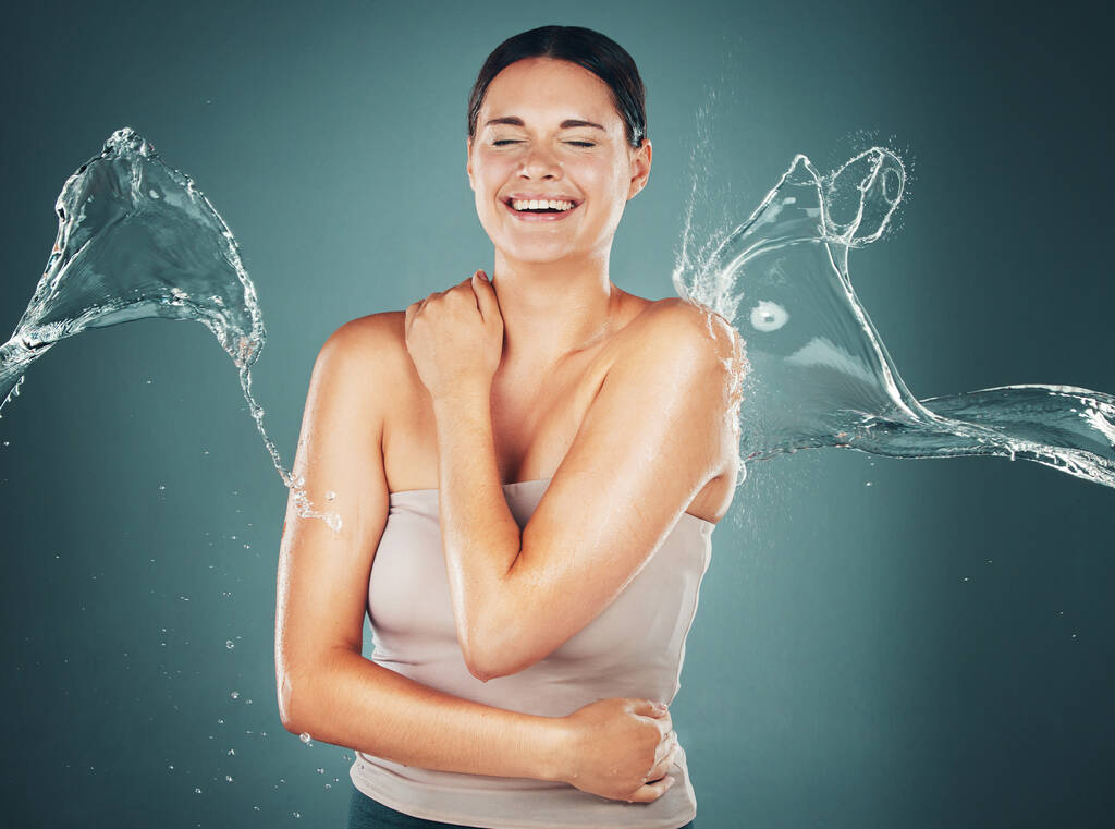 Beauty, skin and skincare water splash on woman cleaning body for hygiene and hydration isolated in a studio background. Self care, wellness and female dermatology for young beautiful adult. - Foto, immagini