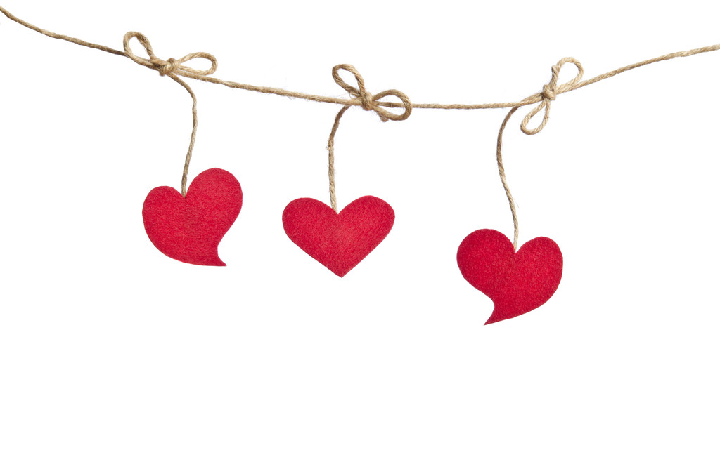 Три красных сердца ткани висит на бельевой веревке изолированы на w
 - Фото, изображение