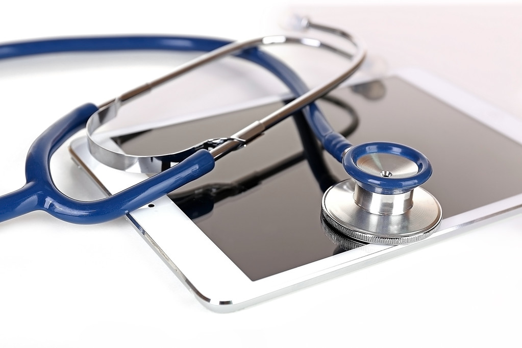 Tablet and blue stethoscope isolated on white - Photo, Image