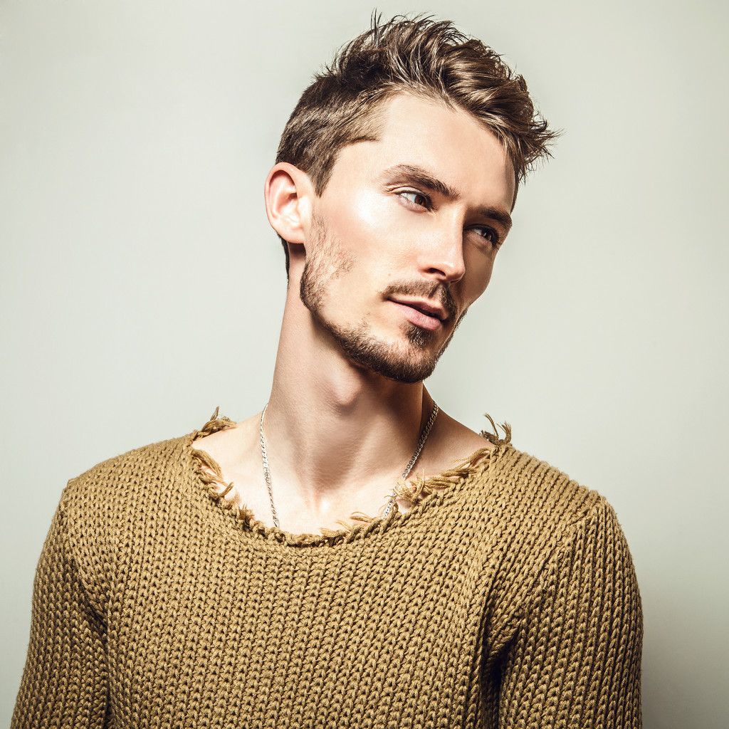 Studio portrait of young handsome man in knitted sweater. Close-up photo. - Photo, Image