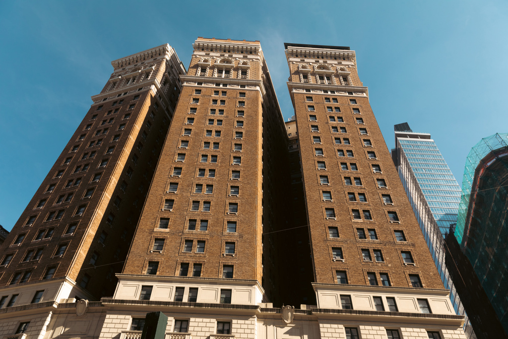 low angle view of Tudor City apartment complex in New York city against blue sky - Zdjęcie, obraz