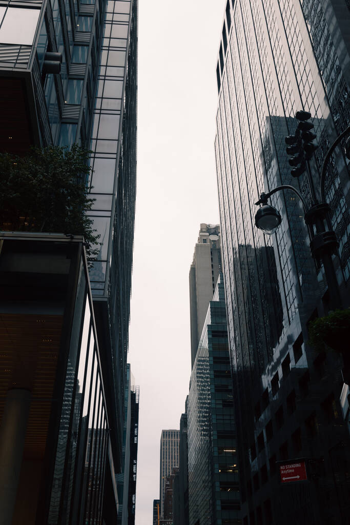 low angle view of modern high-rise buildings on urban street of New York City - Fotó, kép
