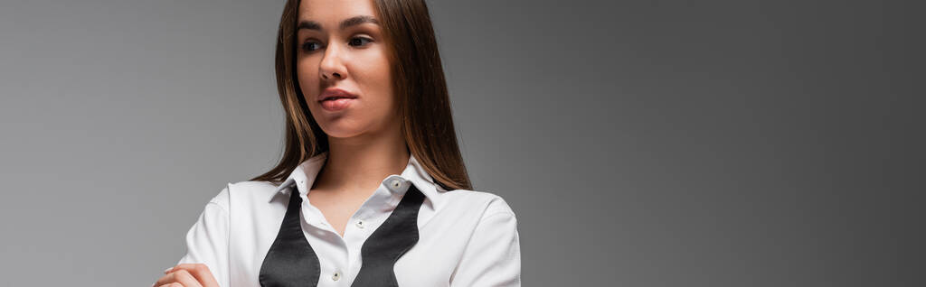 portrait of confident woman in white shirt and black tie looking away isolated on grey, gender equality concept  - Foto, imagen