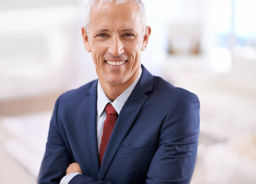 Approaching business with a smile. Portrait of a smiling businessman with folded arms - Foto, afbeelding