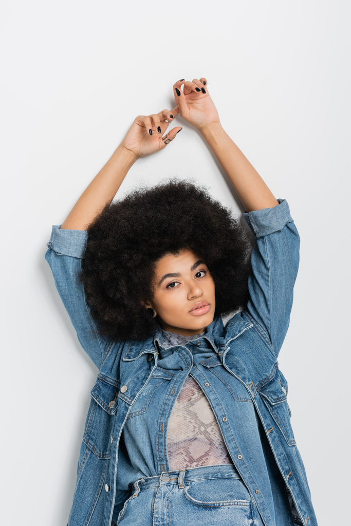 African american woman in denim clothes posing on grey background - Foto, afbeelding