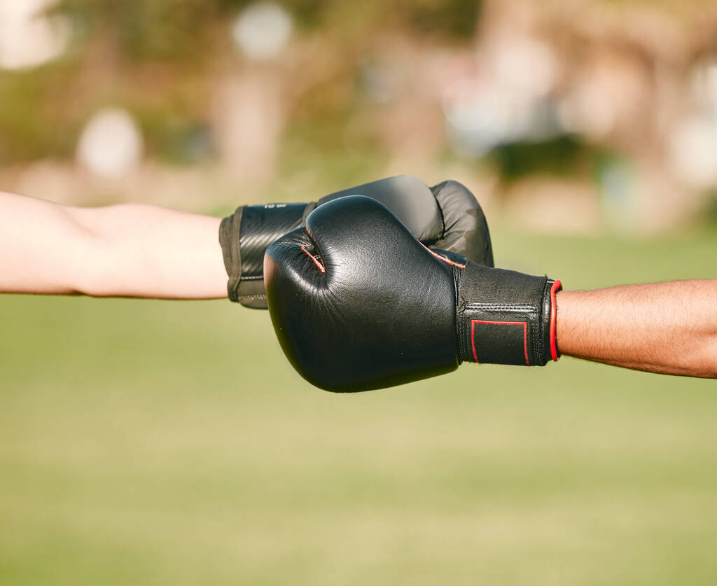Team, boxing gloves and people fist bump in celebration, collaboration and teamwork in combat sports outdoors. Boxer, hands and friends or fighter training together as workout, exercise and fitness. - Zdjęcie, obraz