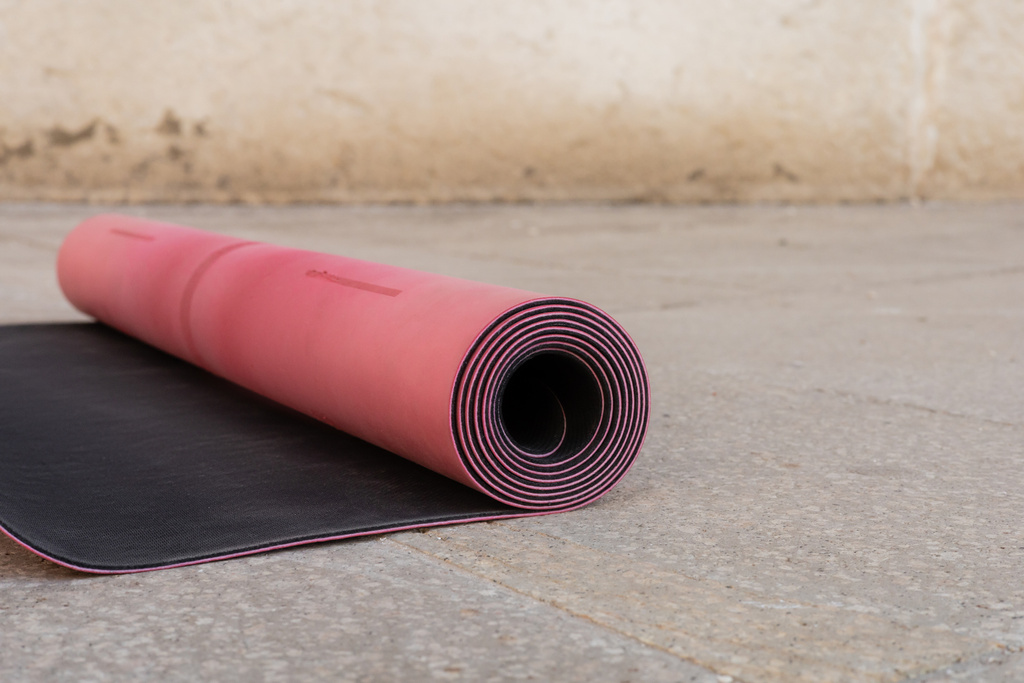 close up view of pink and black fitness mat on sidewalk outdoors, copy space, urban lifestyle  - Photo, Image