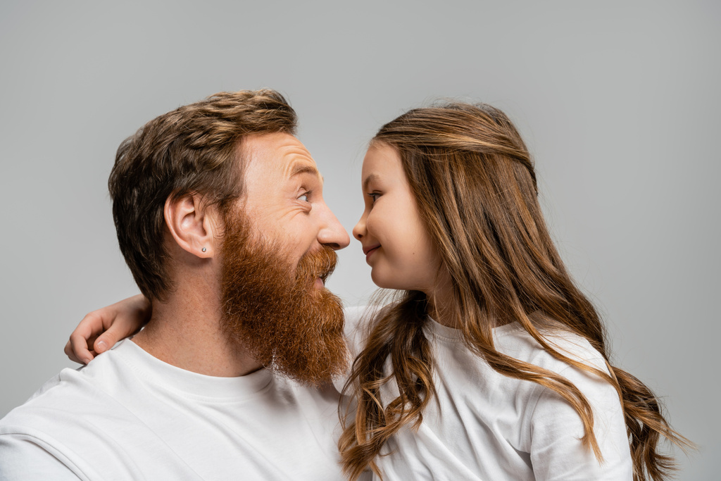Side view of smiling father and kid standing nose to nose isolated on grey  - Photo, Image