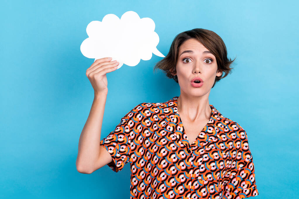 Photo of impressed funny lady dressed print shirt holding speaking bubble empty space isolated blue color background. - Photo, Image