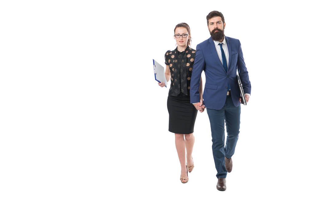 Opportunity to work closely. Business couple hold hands isolated on white. Sensual woman and bearded man in formalwear. Independent work or dependent wage-paid work. Employment or work. - Photo, Image