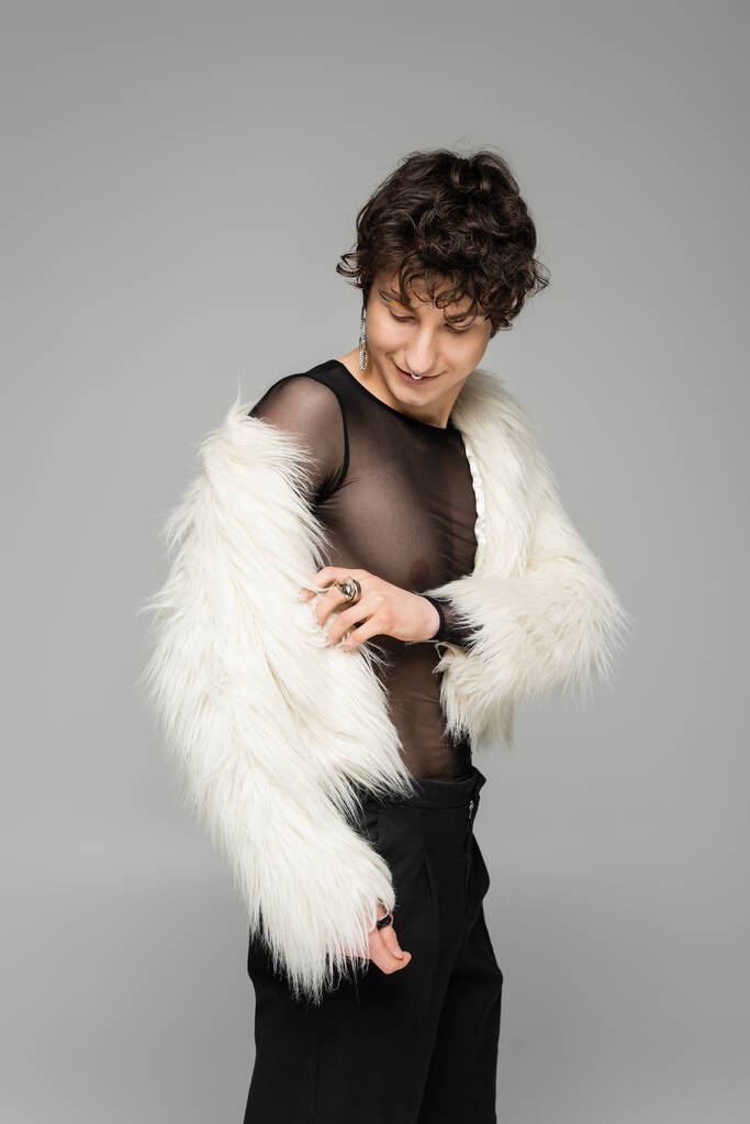 brunette nonbinary person wearing white faux fur jacket isolated on grey - Photo, Image
