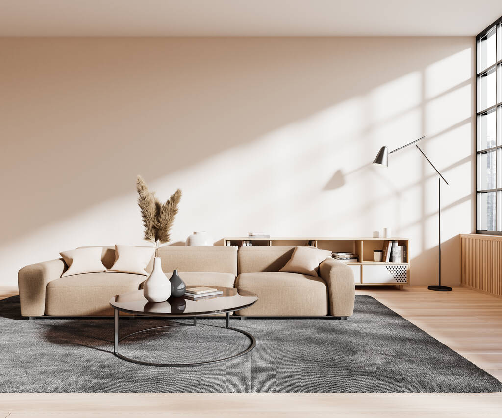 Интерьер современной гостиной с бежевыми стенами, деревянным полом, удобным бежевым диваном и круглым журнальным столиком, стоящим на ковре. 3d-рендеринг - Фото, изображение