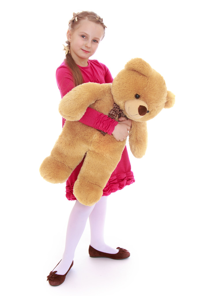 Vrij klein meisje knuffelen een teddybeer. - Foto, afbeelding