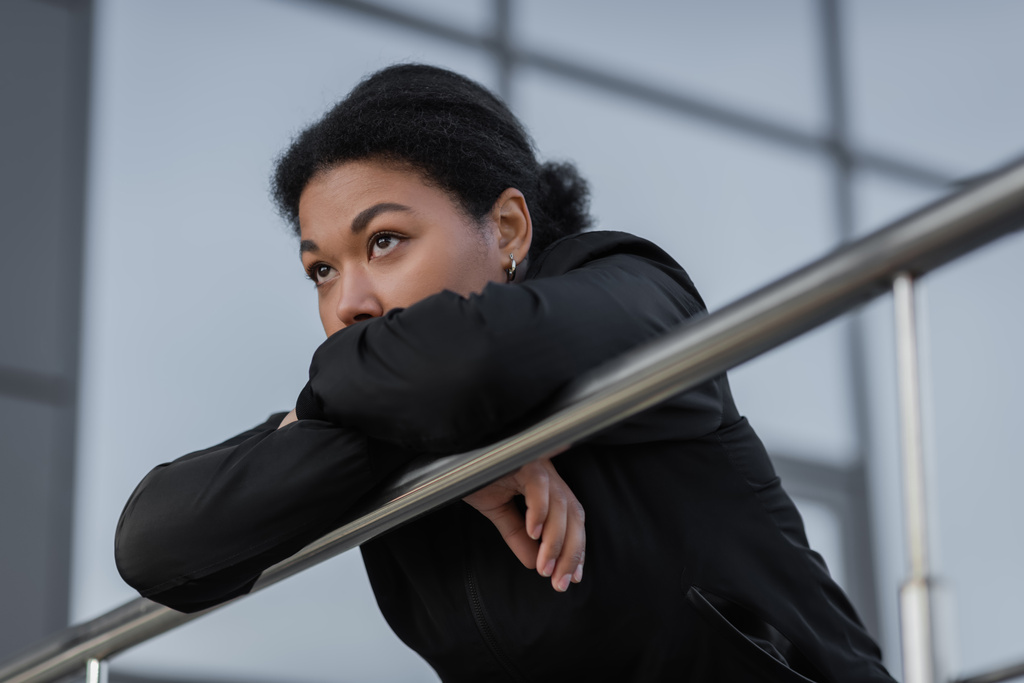 multiracial woman with mental crisis standing near railing on urban street  - Photo, Image