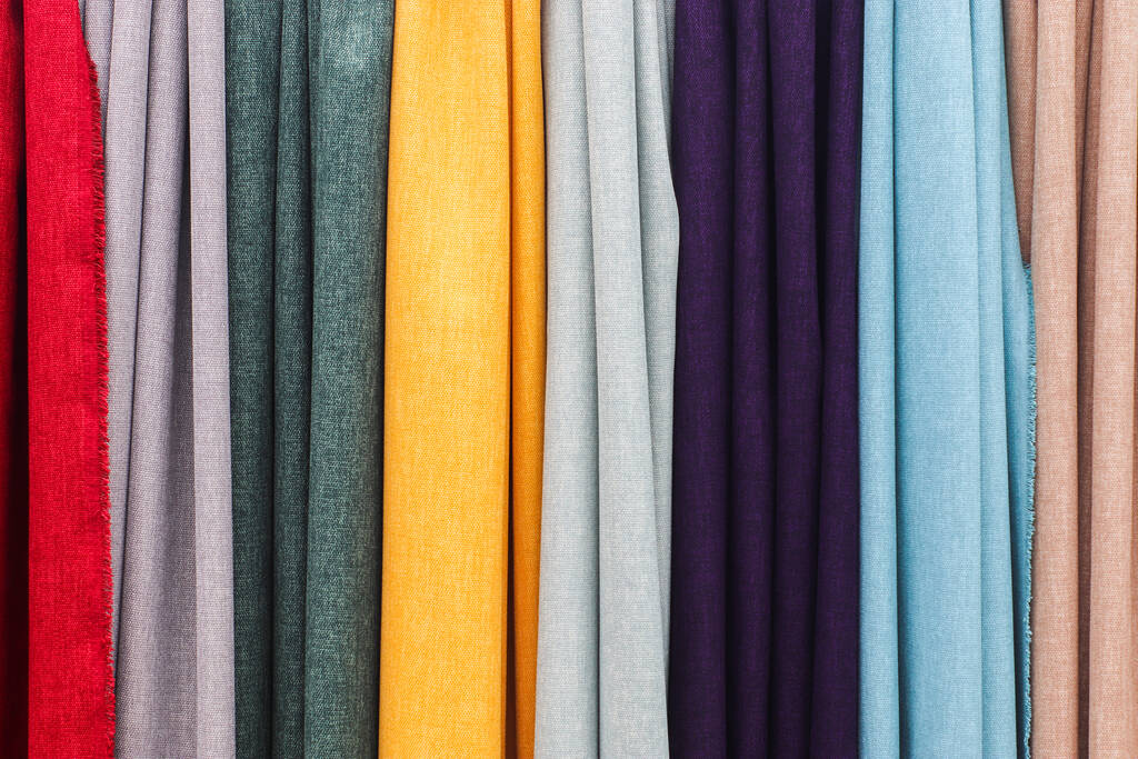 Samples of cloth and fabrics in different colors found at a fabrics market. - Photo, Image