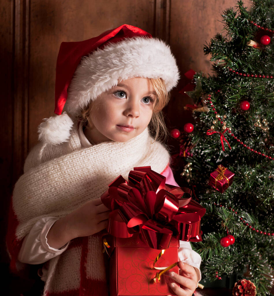 child in a suit of Santa Claus in the room decorated to new year - Photo, Image