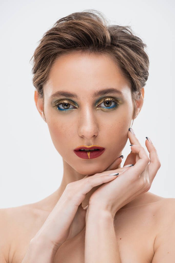 young woman with short hair and bright makeup looking at camera isolated on grey  - Photo, Image