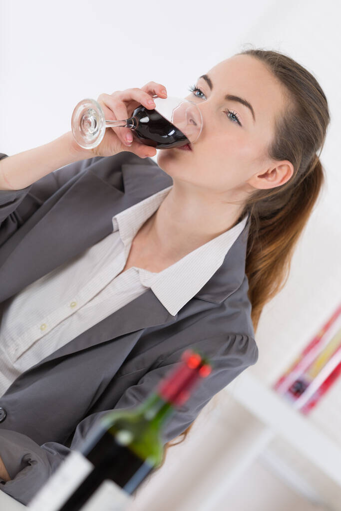 vrouw die rode wijn drinkt in restaurant - Foto, afbeelding