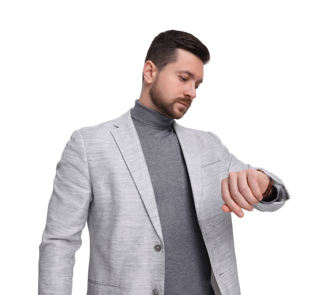 Handsome bearded businessman checking time on white background - Photo, Image
