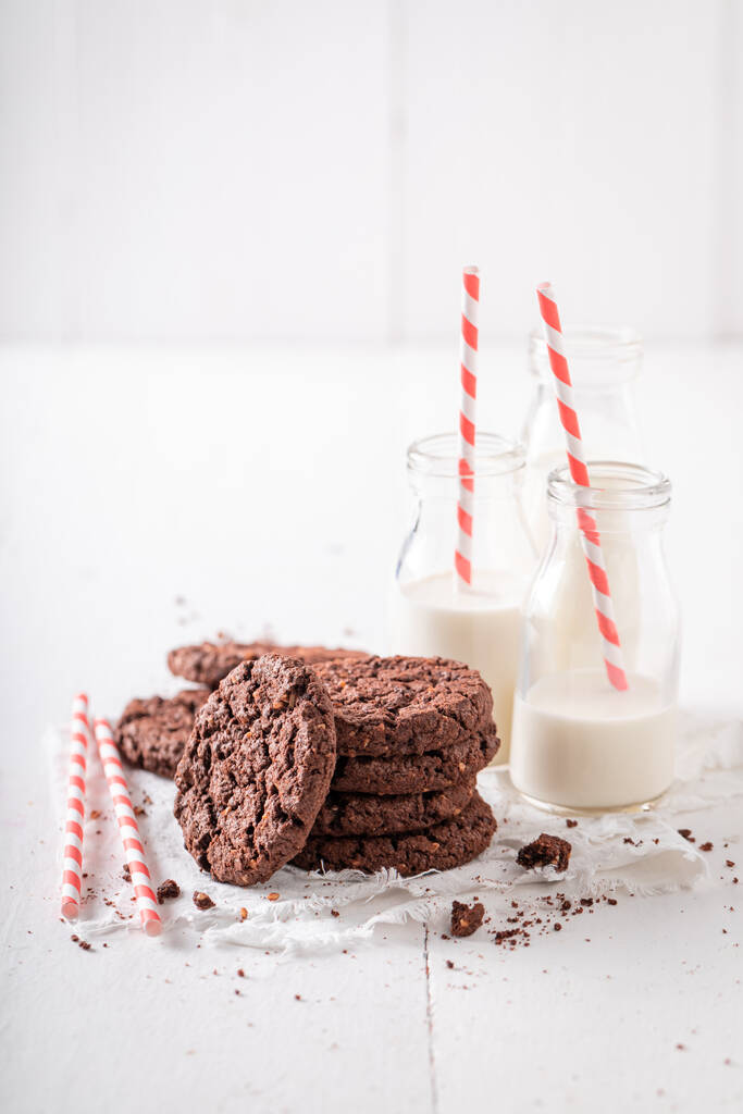 Homemade brown cookies served with milk in bottle. Chocolate cookies with milk. - Photo, Image