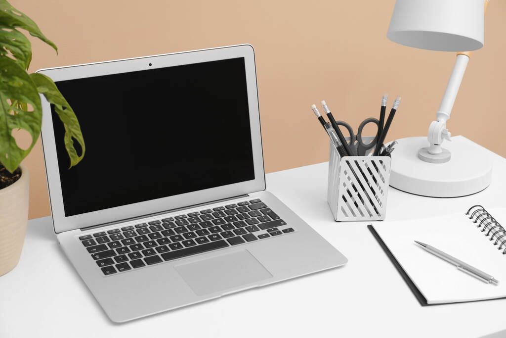 Cozy workplace with laptop and stationery on desk. Home office - Zdjęcie, obraz