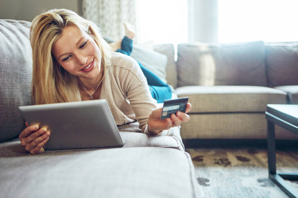 Minden oka megvan rá, hogy online vásároljon. egy fiatal nő kezében a digitális tabletjét, a másik kezében a hitelkártyáját. - Fotó, kép