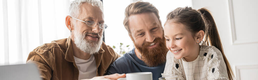 Overjoyed homosexual parents spending time with daughter at home, banner  - Photo, Image