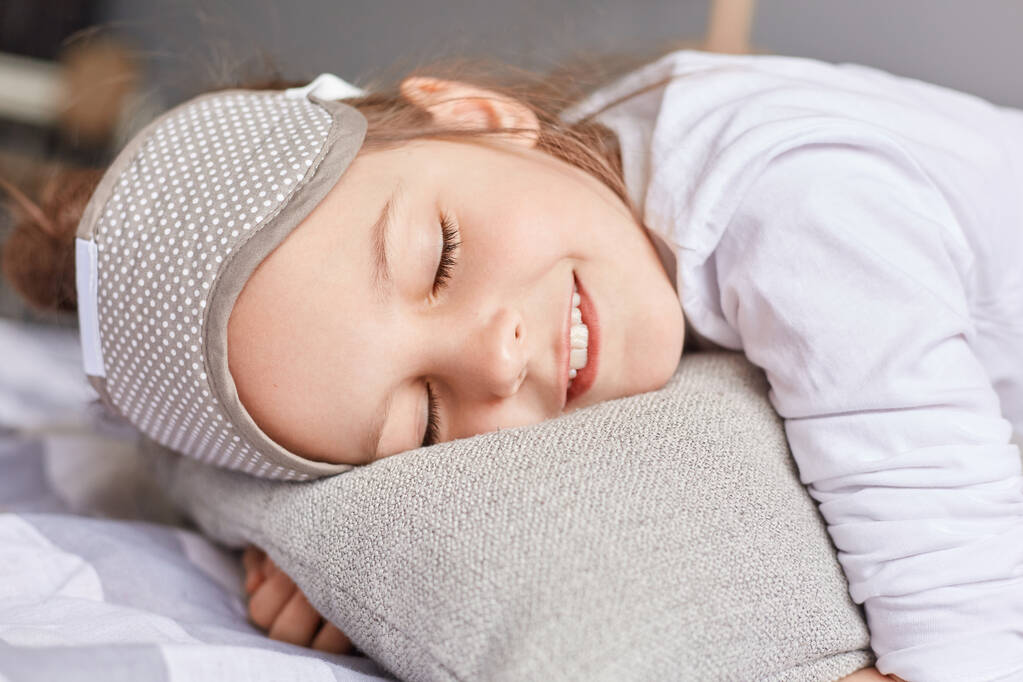 居心地の良いベッドでよく眠る愛らしい白人の女の子,かわいい子供は柔らかい枕の昼寝に横たわっています,穏やかな子供の休息,ベッドルームでの健康的な平和的な睡眠. - 写真・画像