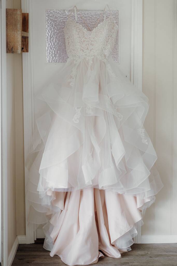 A selective of a bride's dress hanging in a room - Photo, Image