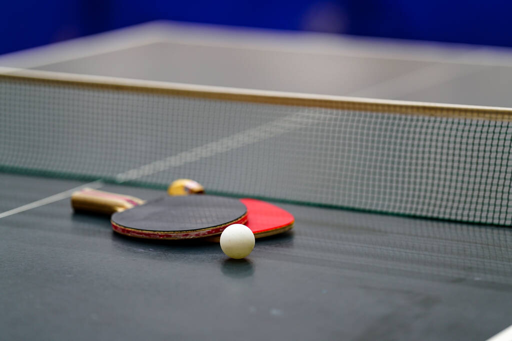 Racket and ball on a ping-pong table - Photo, Image