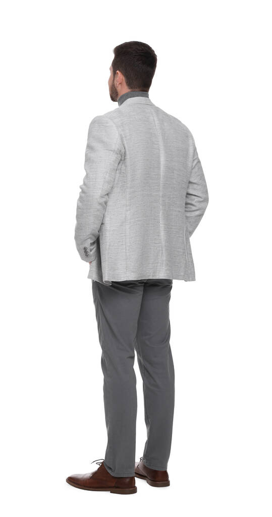 Επιχειρηματίας με κοστούμι στέκεται σε λευκό φόντο - Φωτογραφία, εικόνα