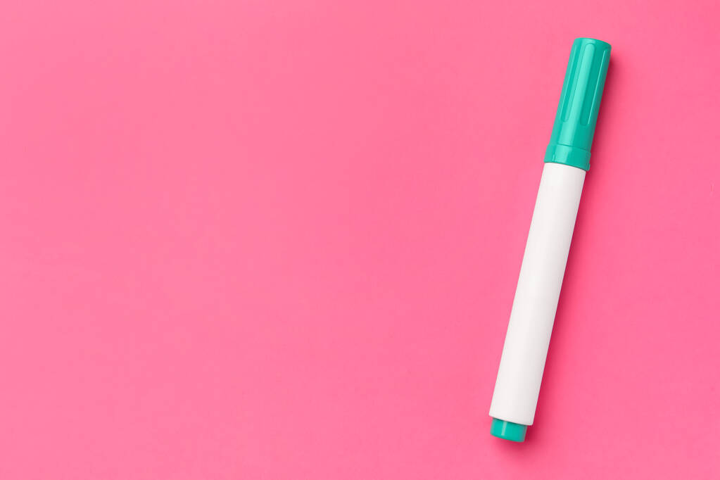 Bright green marker on pink background, top view. Space for text - Photo, Image