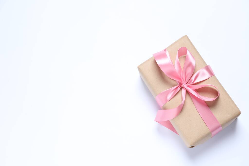 Beautiful gift box with pink bow on white background, top view. Space for text - Photo, Image