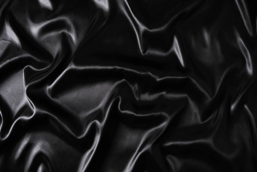 Hedvábná tkanina, abstraktní vlnité černé saténové tkaniny pozadí - Fotografie, Obrázek