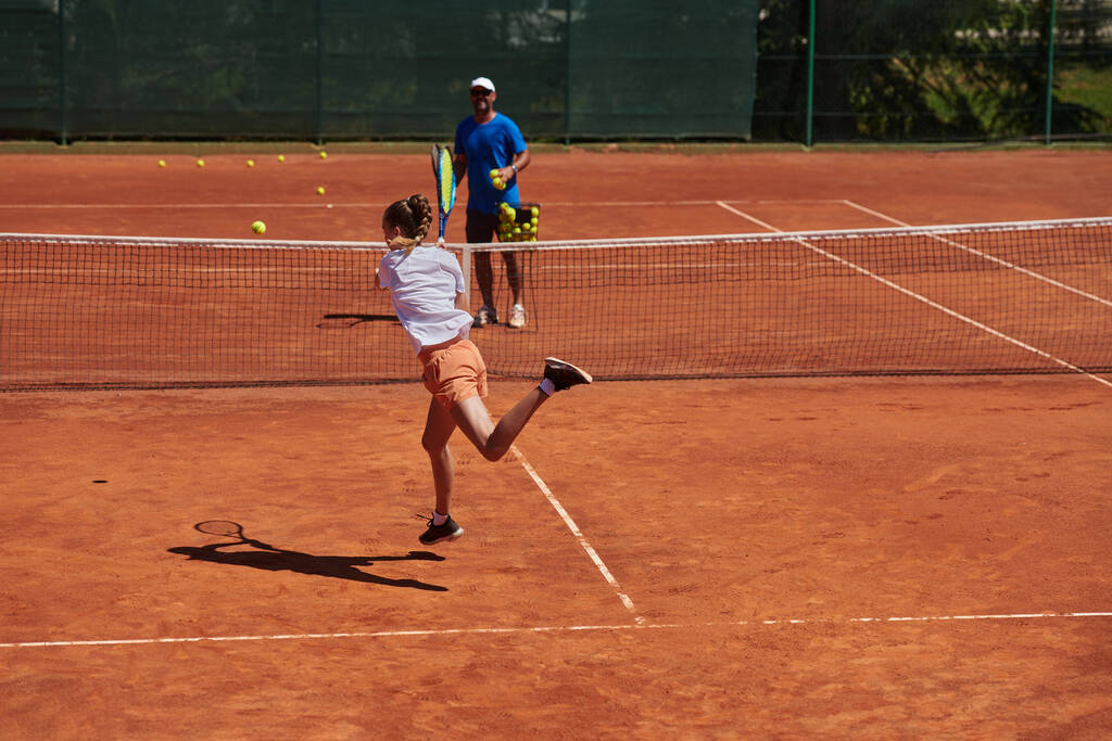 Tennispelaaja ja hänen valmentajansa treenaavat aurinkoisena päivänä tenniskentällä. Ammattimaisen tennispelaajan koulutus ja valmentaminen. - Valokuva, kuva