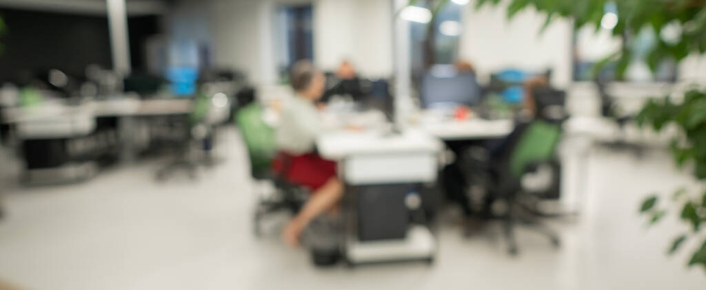 Blurry photo. Four colleagues at their desks - Photo, Image