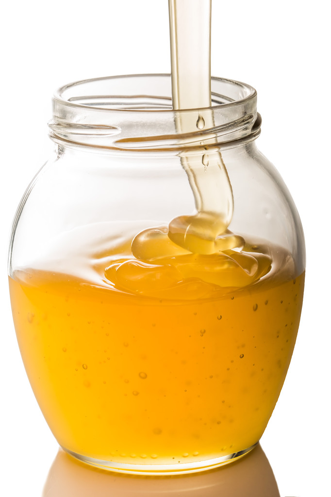 obrázek ze sklenice medu izolovaných na bílém pozadí - Fotografie, Obrázek