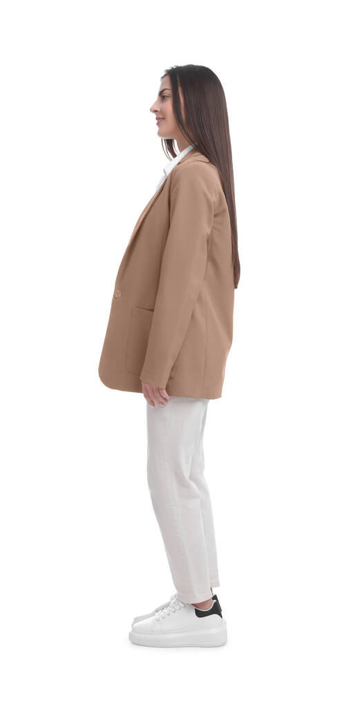 Fiatal üzletasszony öltönyben áll fehér háttér - Fotó, kép