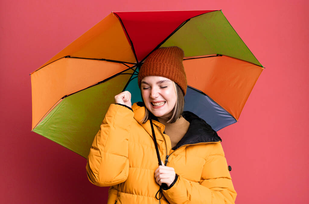 young pretty woman wearing an anorak and a umbrella - Zdjęcie, obraz