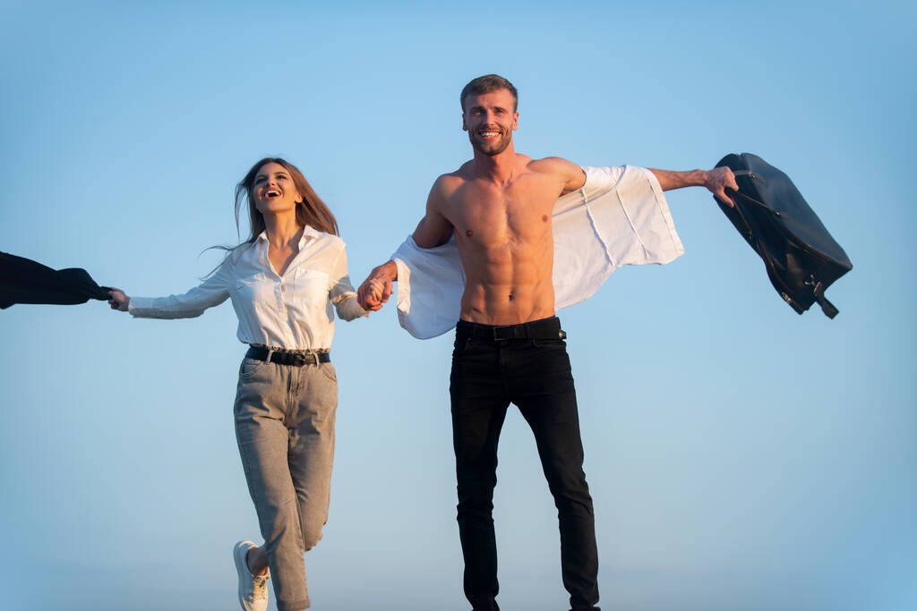 Excitement couple enjoying weekend. Excited and joyful couple travelling outdoor. Excited carefree couple travellers. Shirtless man and young excited woman open arms ready to travel. Freedom couple - Photo, Image