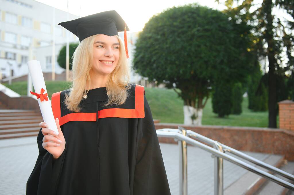 Portrait d'une femme heureuse le jour de sa remise des diplômes à l'université. Éducation et personnes - Photo, image