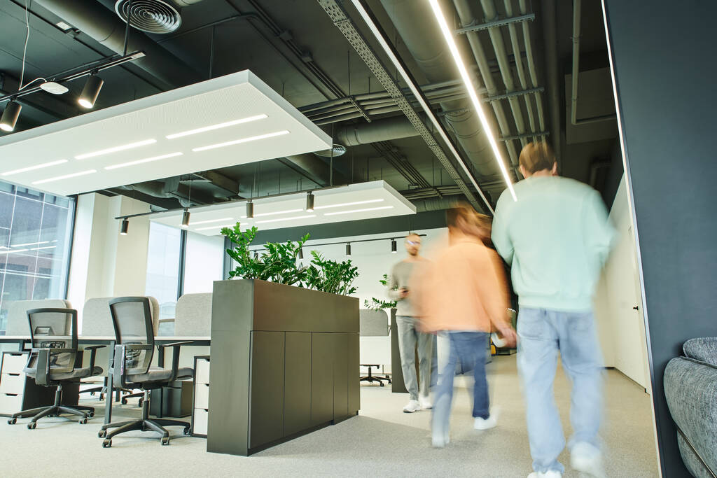 motion blur of businessmen walking in contemporary and spacious coworking office with modern furniture, green natural plants and high tech interior, movement, dynamic business concept - Photo, Image