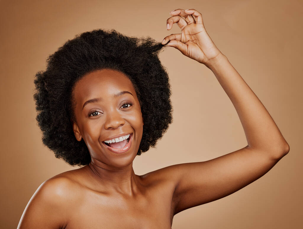 Face, excited black woman and hair care for afro in studio isolated on a brown background. Portrait, hairstyle or happy African model with natural cosmetics after salon treatment for healthy wellness. - Photo, Image