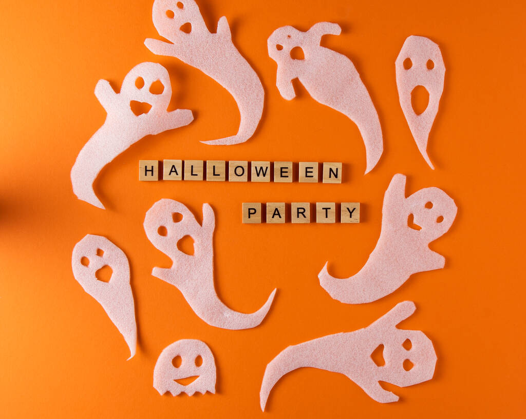 White ghosts craft for Halloween party. Wrapping paper ghost on orange background top view. Cartoon creepy Whisper. DIY hand made. Set boo characters. Word wooden letter phrase. - Photo, image