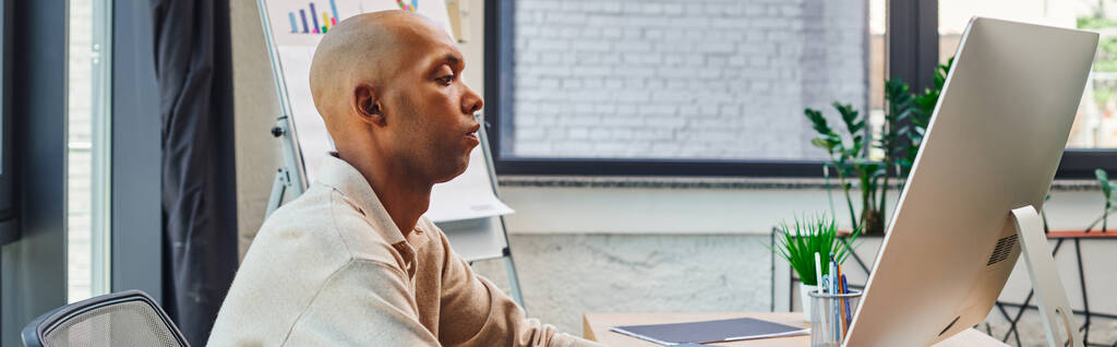 inclusion, african american man with myasthenia gravis at work, bold and dark skinned office worker using computer, looking at monitor, graphs and flipchart on background, banner  - Photo, Image
