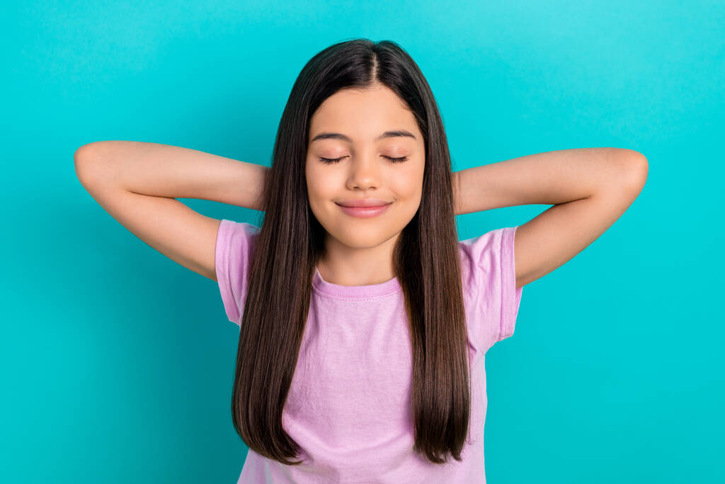 Photo of relaxed cute schoolkid girl hands head comfort take nap sleeping after classes vacation isolated on aquamarine color background. - Photo, Image
